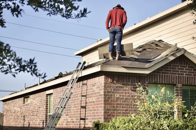Professional roofer working on a residential roof in Desert Hot Springs